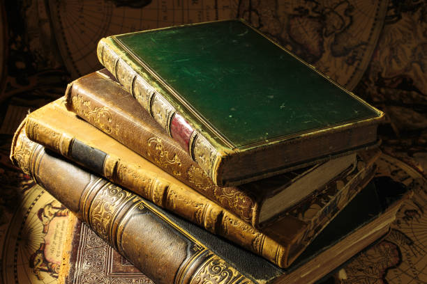 istock Stack of antique books. Old books on vintage map background 1403794243