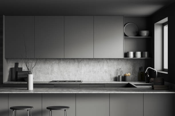 istock Grey kitchen interior with island and seats, shelves and decoration, window 1403794864