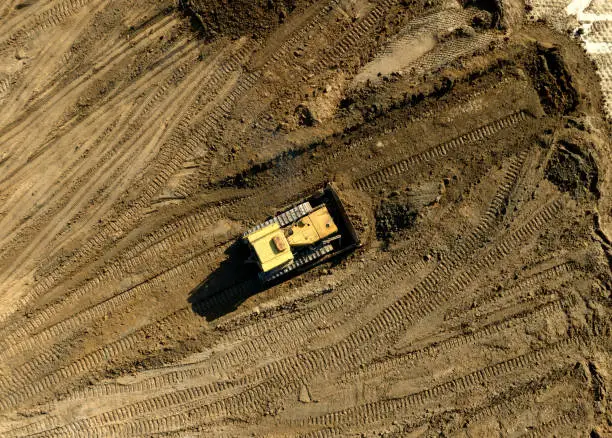 Photo of Bulldozer at mine reclamation once mining sand is completed. Land clearing, grading, pool excavation, utility trenching.