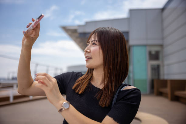 istock Woman taking photos at airport observation deck 1403795840