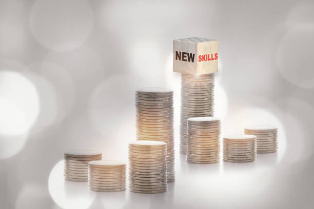 istock New skills on cube on stack of coins on abstract background. 1403797085
