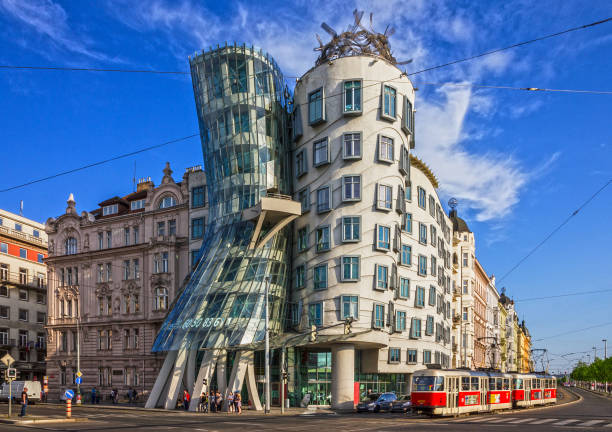 Dancing modern house named "Fred and Ginger" Prague, Czech Republic - May 30, 2022: Prague tram near Dancing modern house named "Fred and Ginger" dancing house prague stock pictures, royalty-free photos & images
