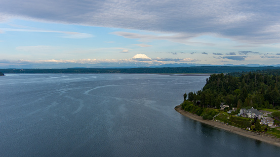 Aerial view of Mount Rainier on the horizon from above the Puget Sound at Nisqually Reach
