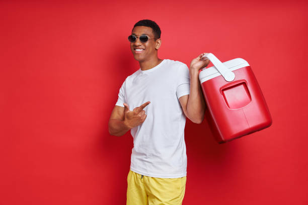 istock Cheerful mixed race man pointing cooler box 1403798842