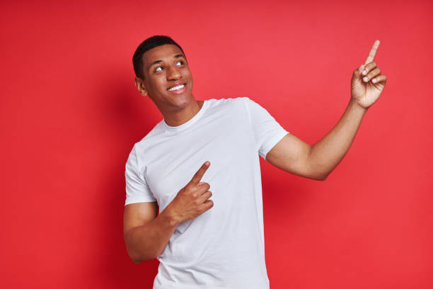 istock Cheerful mixed race man pointing away 1403798859