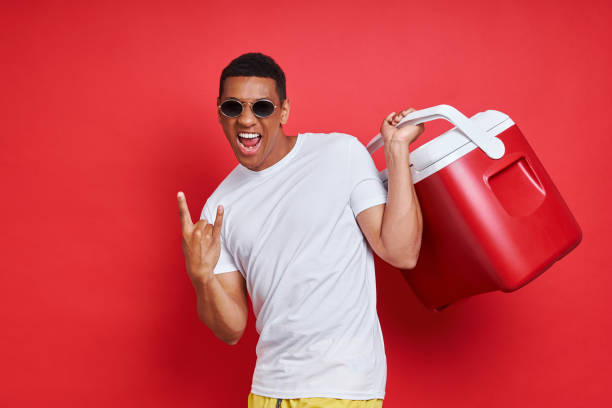 istock Excited mixed race man carrying cooler box and gesturing 1403800585