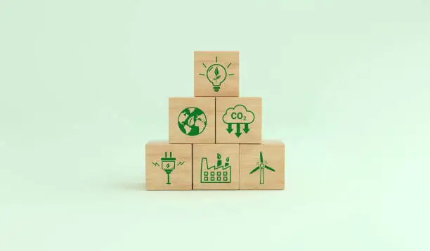 Alternative energies to save the planet. Carbon footprint ecological symbols on a wooden cube. Concept of low carbon emissions. 3D rendering.