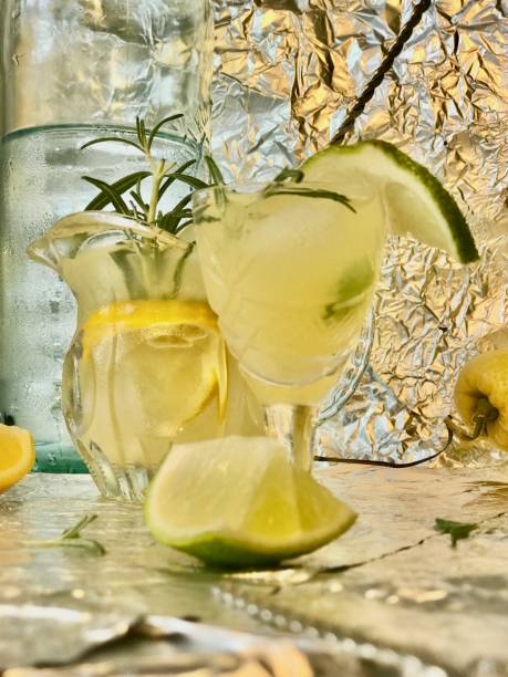 istock Cold lemon drink with alcohol, mint and ice cubes. 1403803228