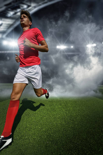 istock Running football player and stadium 1403803253