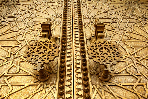 Fez, Morocco-September 22, 2013: Close-up details of Islamic patterns and door knockers on the Haj Gate in Fez.