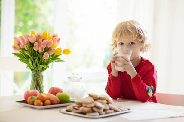 istock Child eating breakfast. Kid drinking milk. 1403805259