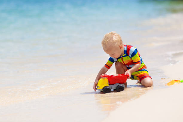 istock Kids playing on beach. Children play at sea. 1403805292