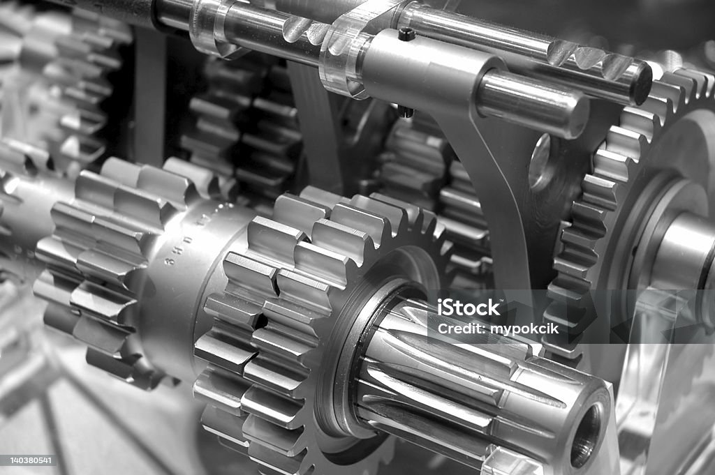 Industrial Gears Background Partial view of gears in a machine in black and white Machinery Stock Photo