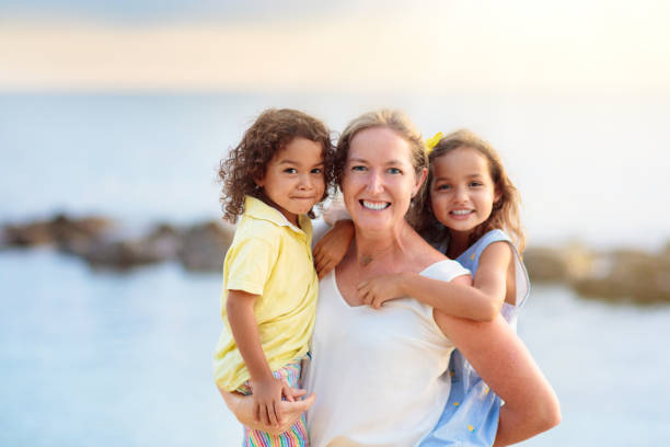 istock Mother and kids on tropical beach. 1403806429