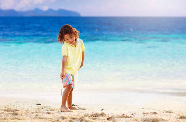 istock Little boy playing on tropical beach. 1403806444