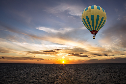 Hot air balloon over sea, Geiranger, Norway. Sunrise, Norwegian cruise