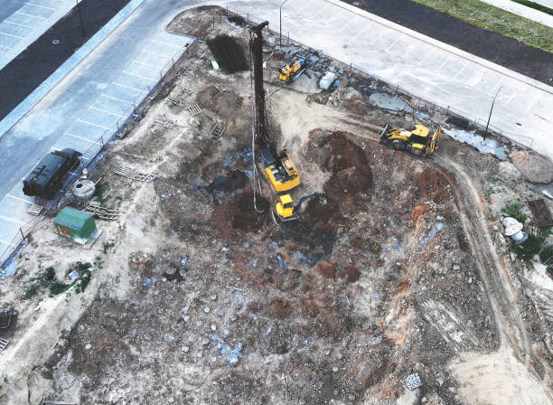 istock Deep foundation machine. Drilling rig and Pile driver at construction site. Pile driven into ground by vibrating hydraulic hammer. 1403809454