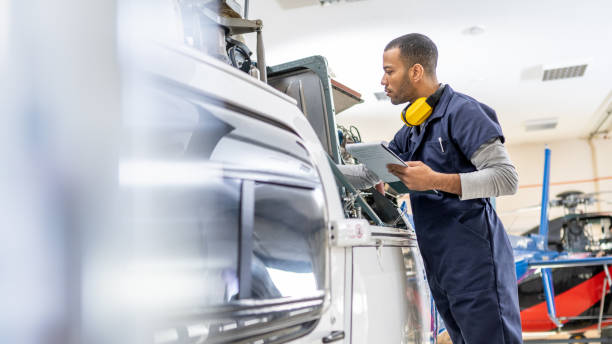 istock Serious African American mechanic standing near jet and fixing engine, side view 1403809561