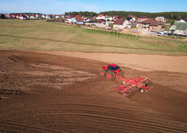 istock Tractor with cultivator plowing field. Tractor disk harrow on ploughing a soil. 1403810275