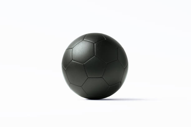 Black soccer ball sitting on white background. Horizontal composition with copy space. Clipping path is included.