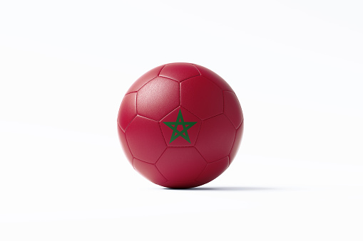 Soccer ball textured with Moroccan flag sitting on white background. Horizontal composition with copy space. Clipping path is included. Qatar 2022 World Cup qualifiers concept.