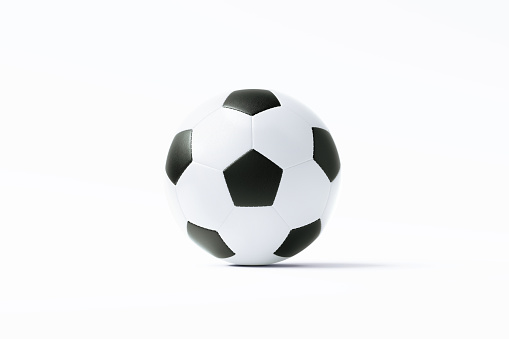 Black and white soccer ball sitting on white background. Horizontal composition with copy space. Clipping path is included.
