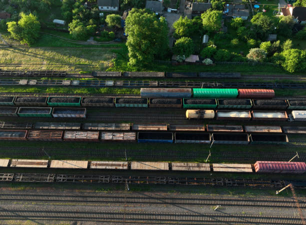 istock Railway yard with freight rail wagons. Cargo trains with goods on railroad. Freight train with petroleum tank cars and shipping containers. 1403810759
