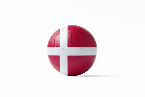 Soccer ball textured with Danish flag sitting on white background. Horizontal composition with copy space. Clipping path is included. Qatar 2022 World Cup qualifiers concept.