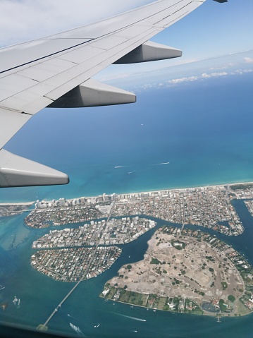 An Aerial View of Part of Miami from a Commercial Airplane Airliner. The plane wing can also be seen in this photograph.