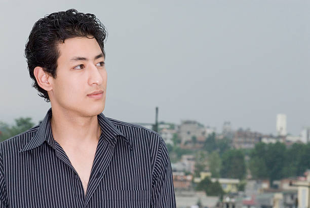 Close-up of a young man looking away stock photo