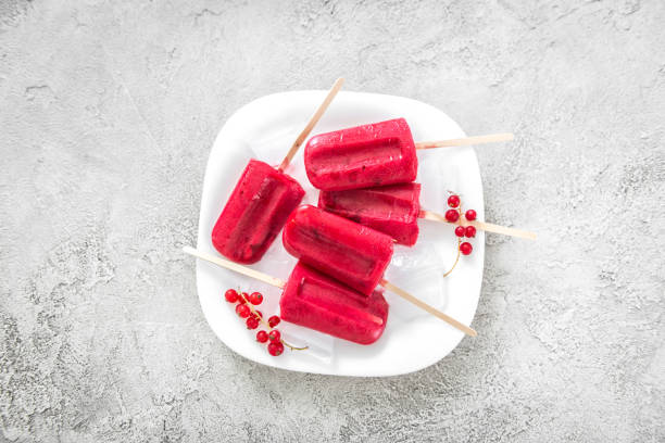 istock homemade ice-cream popsicles with red currant, topview 1403813450