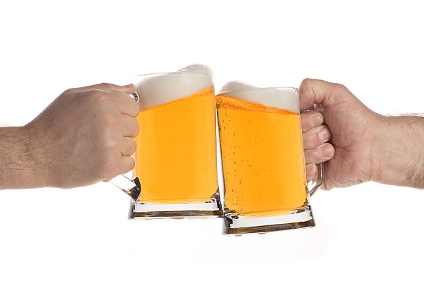 istock Two people making a toast with beer mugs 140381369