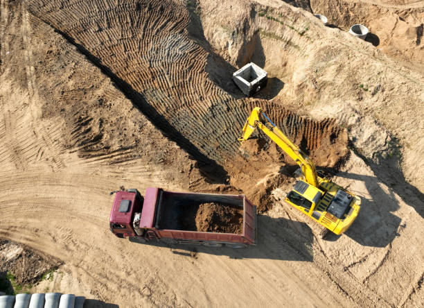 istock Excavator load sand in dump truck. Earthworks on construction site. 1403815757