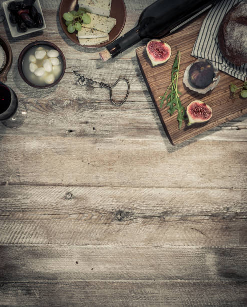cheeses and brown bread on wooden table with text space