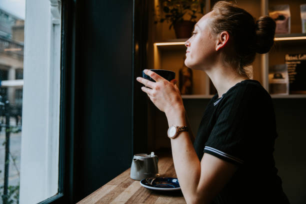 istock Beautiful woman relaxing and drinking hot tea 1403816609