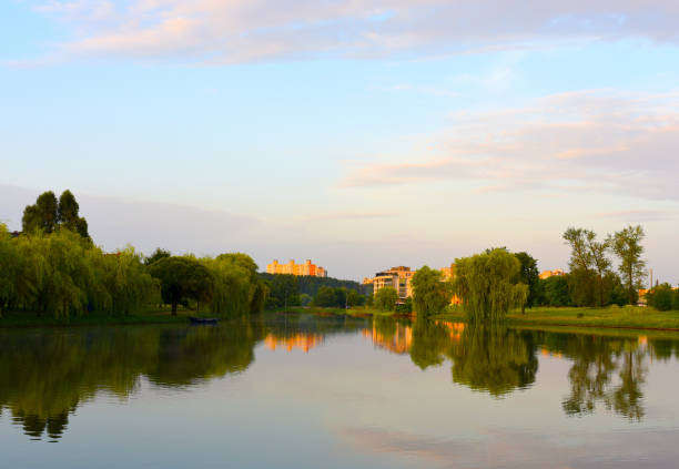 Modern residential buildings skyline near lake in autumn park