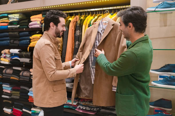 istock Happy store owner and customer holding jacket in showroom 1403821730