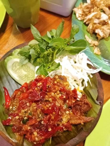istock Ayam Geprek/geprek chicken with cabbage, cucumber and basil leaves 1403823767