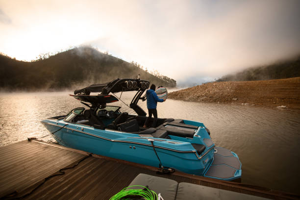 istock blue modern motorboat moored at the pier and a man on it 1403824982
