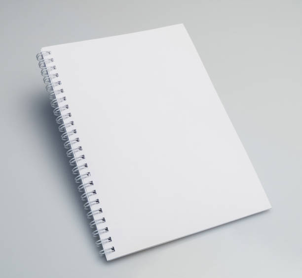 istock Angle shot of an open blank notebook on a white background with copy space. 1403825084