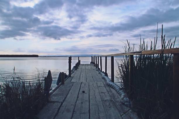 istock Wooden jetty in a lagoon at sunset. 1403825187