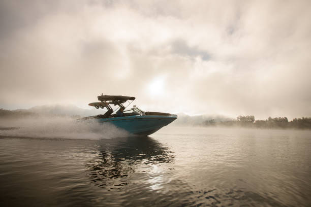 물 위에 빠르게 떠있는 밝은 파란색 모터 보트 - motorboating 뉴스 사진 이미지