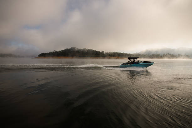 istock beautiful view on water surface and motor boat quickly floating on it 1403825413