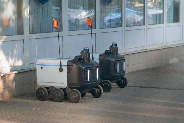 istock Autonomous Delivery Robots on a sidewalk that make food and package deliveries. 1403826080