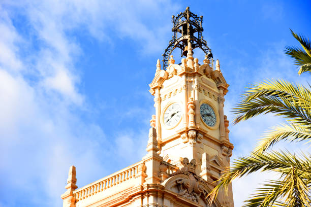 istock Clock tower building. Large clock tower with hour hands that shows the time of day and night. 1403827889