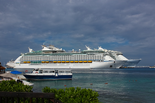 A Cruise ship seen in the middle of the Andaman Ocean near Patong Beach in Phuket, Thailand, during a hot summer day in the tropics.