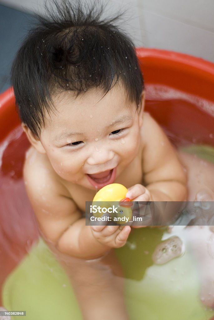 Cute nine month old Asian baby boy having his bath in a bathtub 6-11 Months Stock Photo