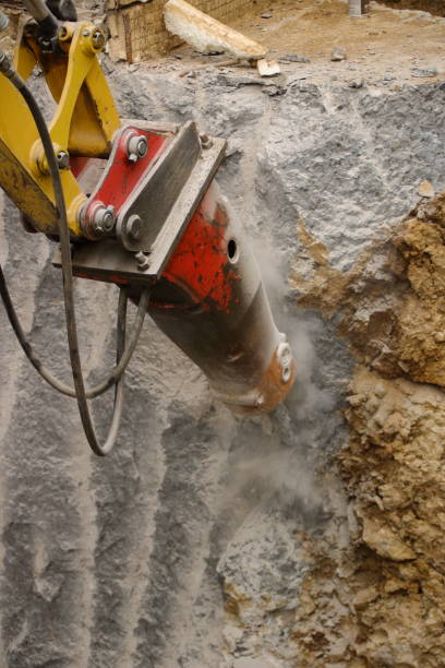 istock Demolition of a house wall with a large chisel 1403829134