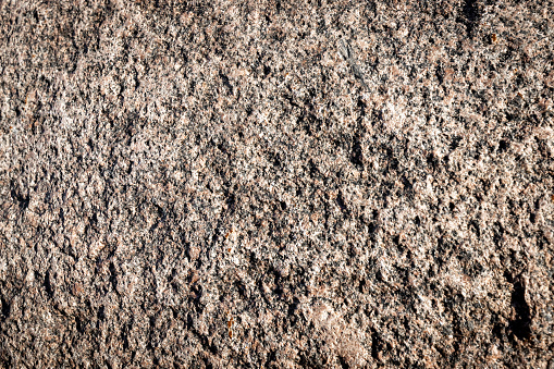 Stone background. Brown rough solid rocky material. Natural porous surface. High quality photo