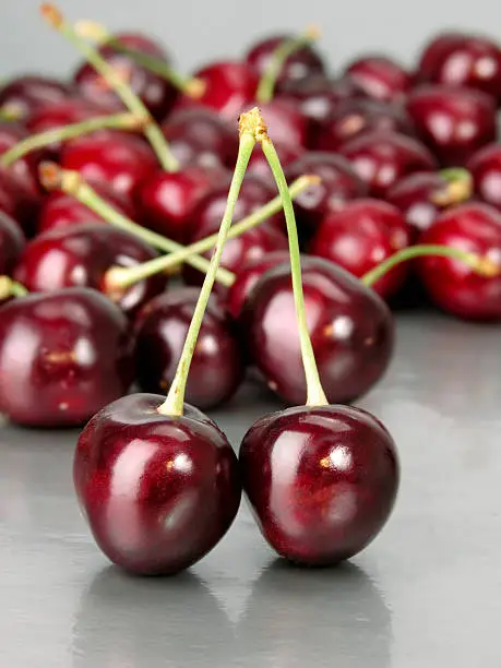 Some cherries on a grey background